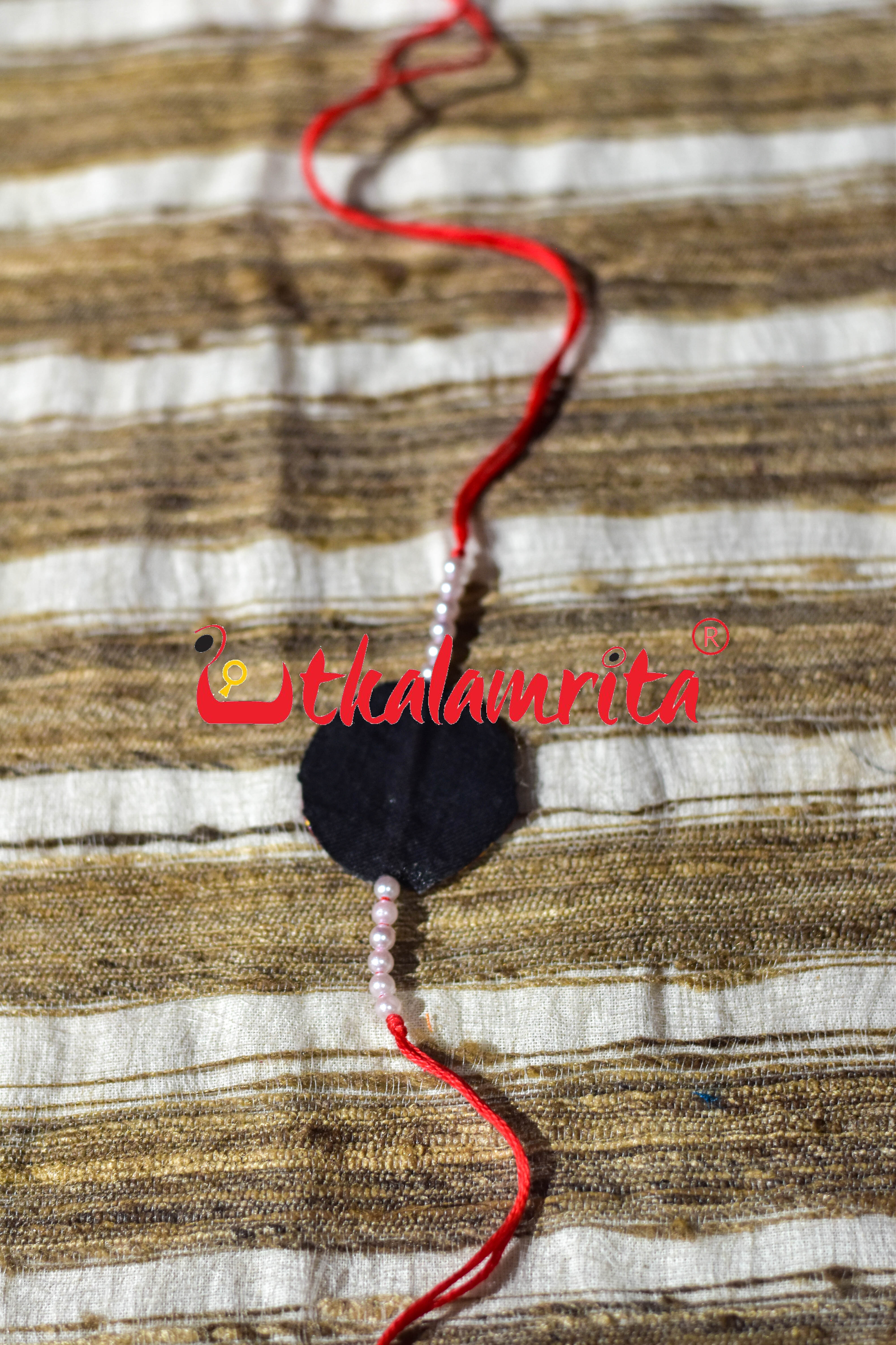 Black Round Flower Pattachitra (Ikat Rakhi)